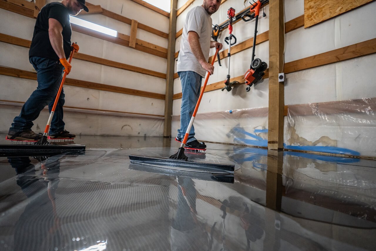 Professional installers applying an epoxy floor coating
